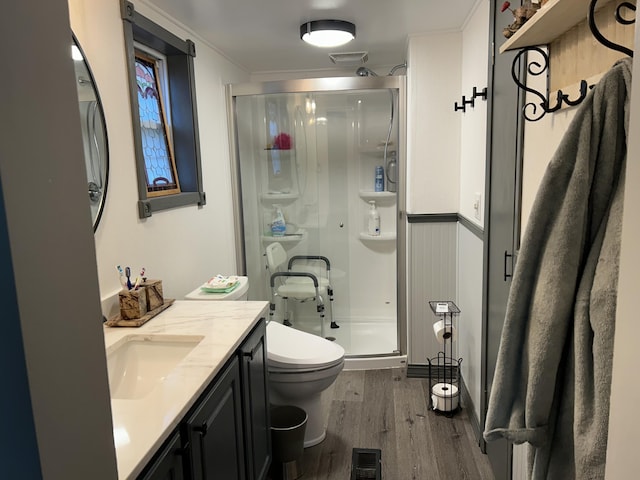 bathroom with vanity, a stall shower, wood finished floors, and visible vents