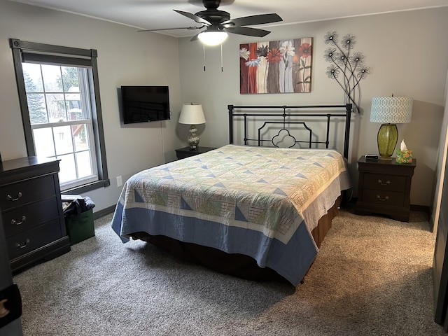 carpeted bedroom featuring a ceiling fan and baseboards