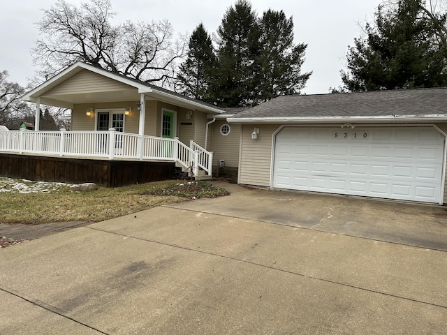 ranch-style home with a porch, concrete driveway, and a garage