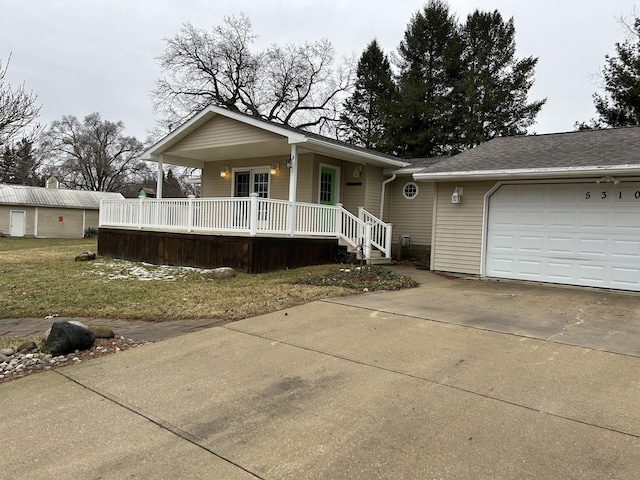 view of front facade featuring a garage, concrete driveway, and a porch