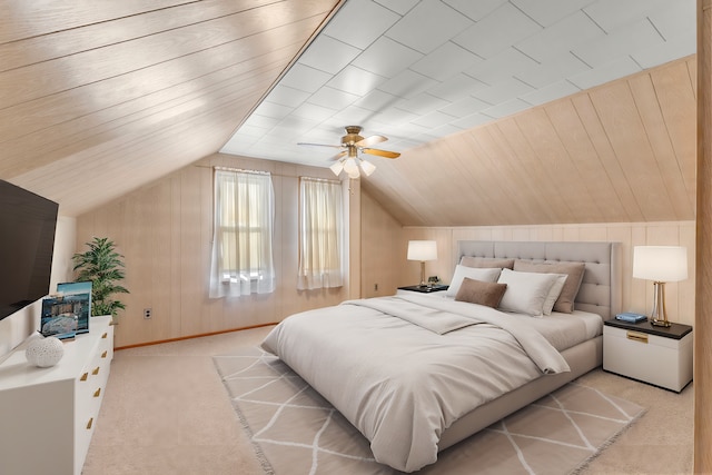 bedroom with light carpet, baseboards, a ceiling fan, vaulted ceiling, and wood walls