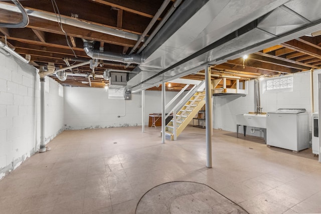 below grade area featuring tile patterned floors, stairway, and independent washer and dryer