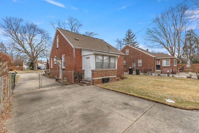 back of house featuring entry steps, a lawn, a gate, fence, and brick siding