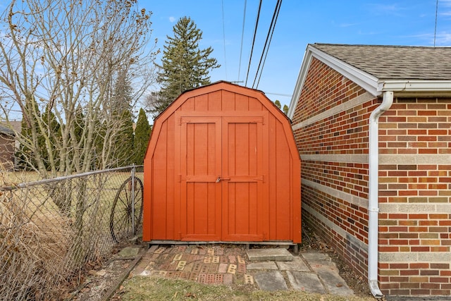 view of shed featuring fence