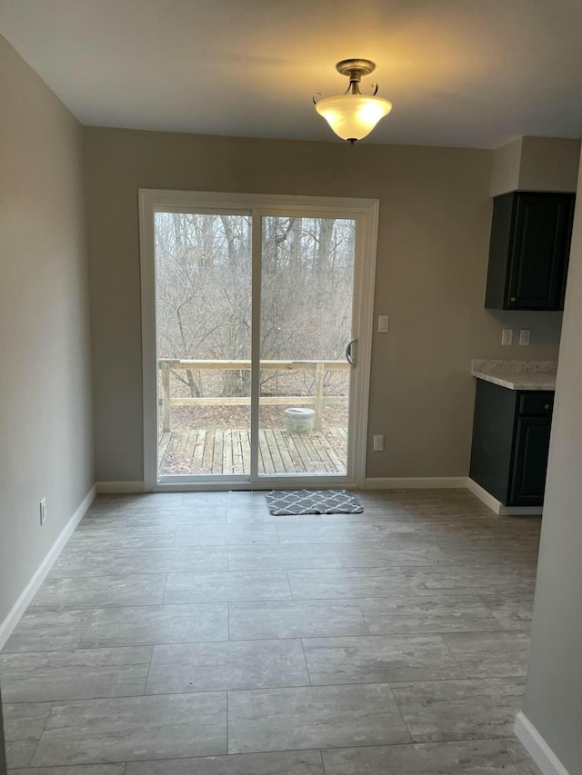 unfurnished dining area with baseboards