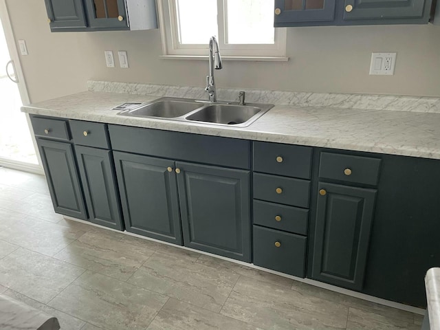 kitchen featuring light countertops and a sink