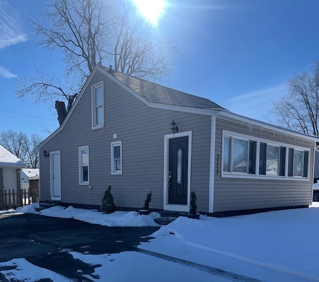 view of front of property with entry steps and roof with shingles