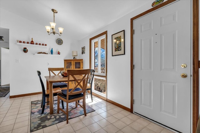 dining room featuring light tile patterned flooring, a notable chandelier, and baseboards