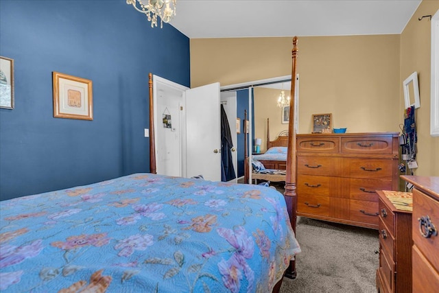 bedroom featuring a closet, a notable chandelier, lofted ceiling, and carpet floors