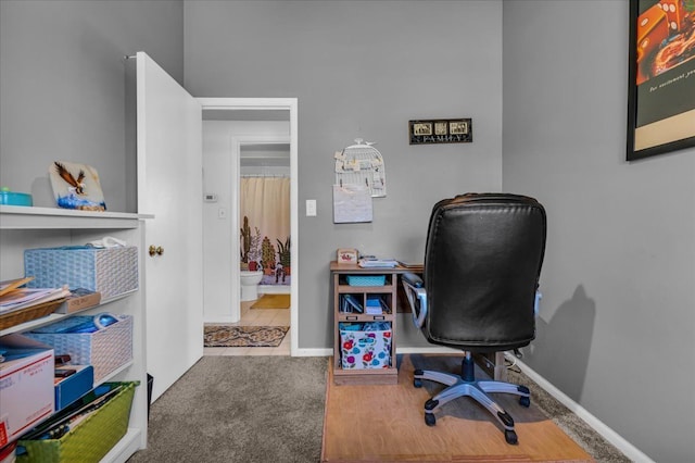 carpeted office space featuring baseboards