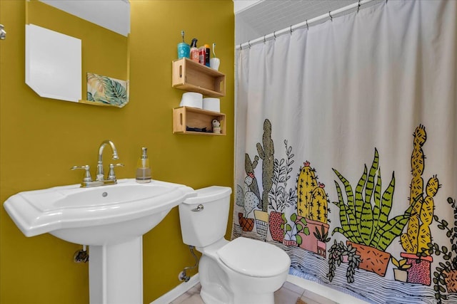 bathroom with a shower with shower curtain and toilet