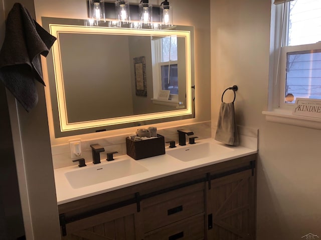 bathroom featuring double vanity, tasteful backsplash, and a sink