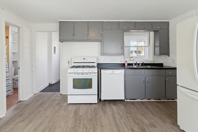 225 E Home St, Edmore, MI 48829 - kitchen with white appliances, gray cabinets, a sink, and light wood finished floors
