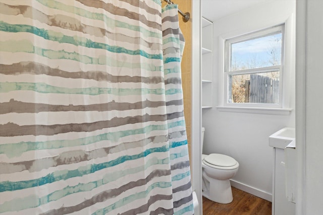 225 E Home St, Edmore, MI 48829 - bathroom featuring toilet, wood finished floors, curtained shower, and vanity