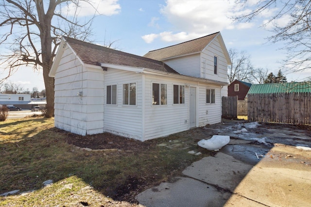 225 E Home St, Edmore, MI 48829 - view of property exterior featuring roof with shingles
