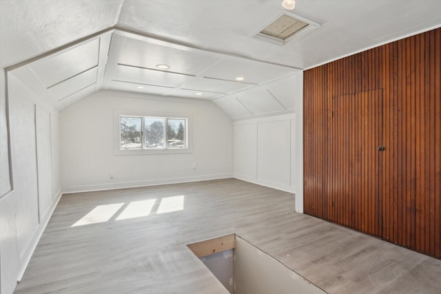 225 E Home St, Edmore, MI 48829 - additional living space featuring wood finished floors, vaulted ceiling, baseboards, and attic access