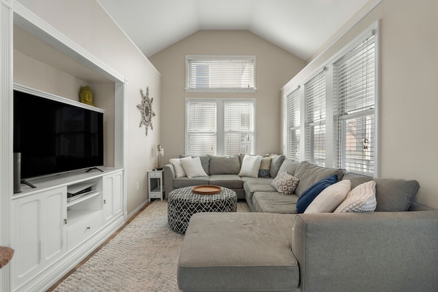 living room with lofted ceiling and baseboards