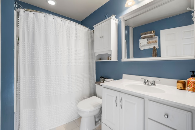 bathroom with tile patterned flooring, vanity, and toilet