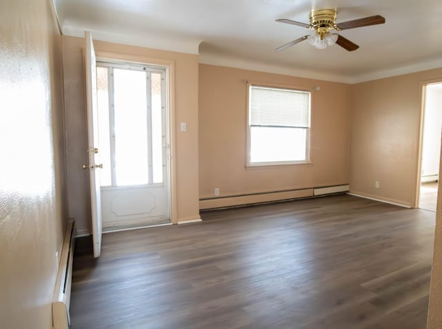 foyer entrance featuring dark wood-style flooring, plenty of natural light, and baseboard heating