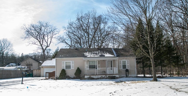 view of front of home featuring a porch and fence