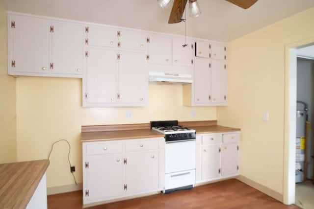 kitchen featuring white range with gas stovetop, white cabinets, a ceiling fan, wood finished floors, and under cabinet range hood