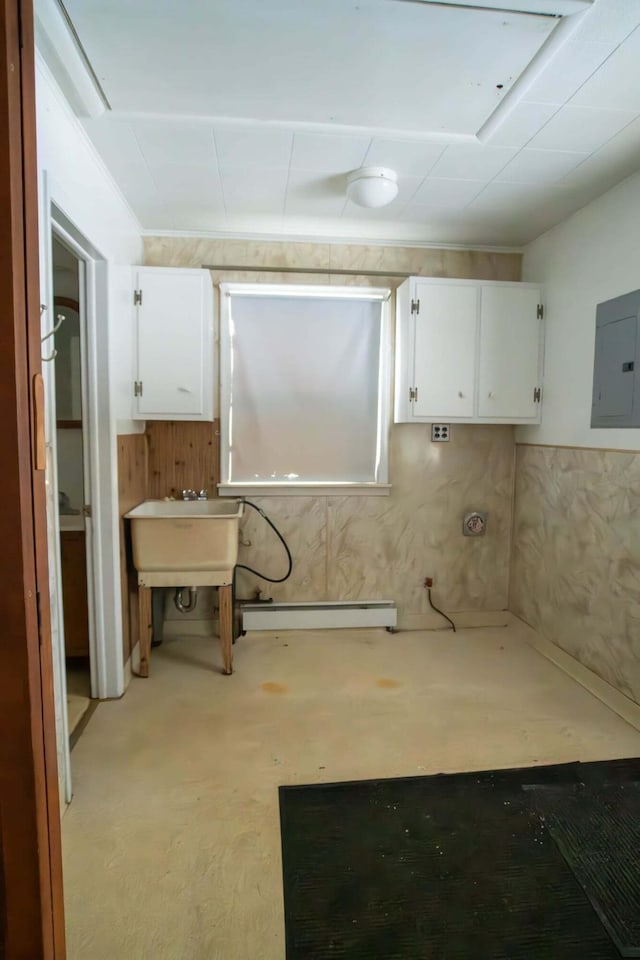 interior space with a baseboard heating unit, a sink, and electric panel