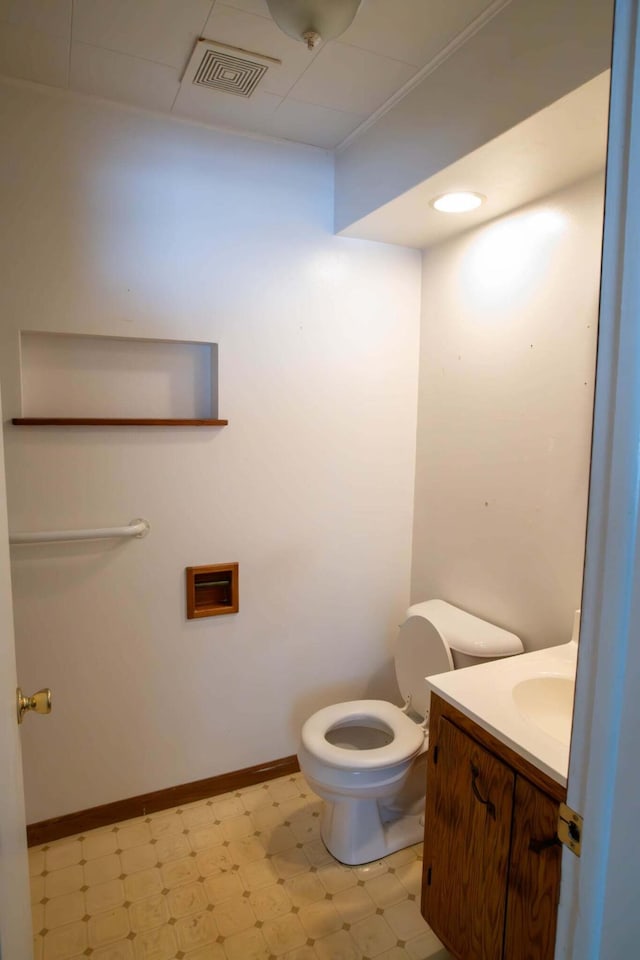 bathroom with toilet, baseboards, visible vents, and tile patterned floors