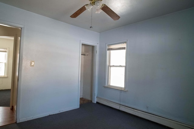 unfurnished bedroom featuring carpet floors, a baseboard radiator, a closet, and ceiling fan