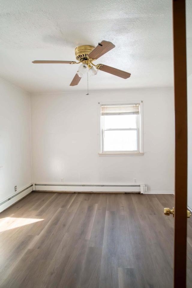 unfurnished room with a textured ceiling and wood finished floors