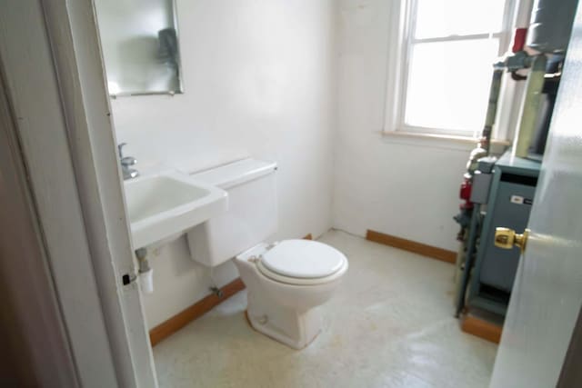 bathroom with toilet and baseboards