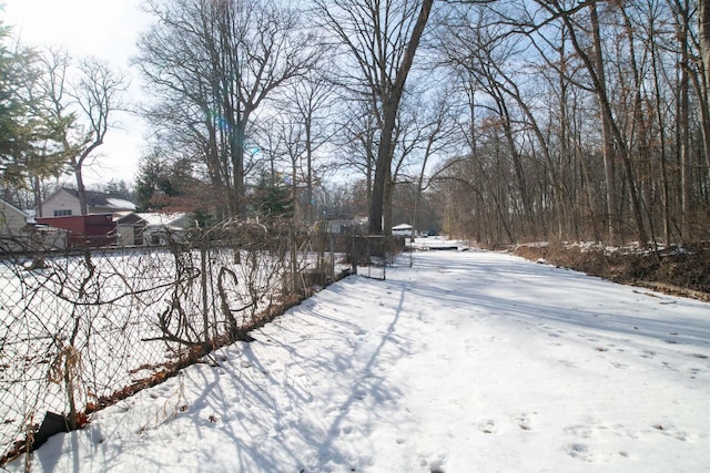 snowy yard with fence