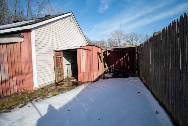 exterior space featuring an outbuilding and fence