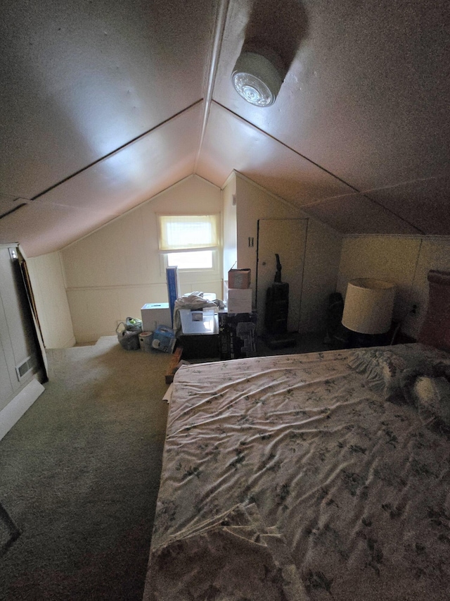 bedroom with lofted ceiling and carpet flooring