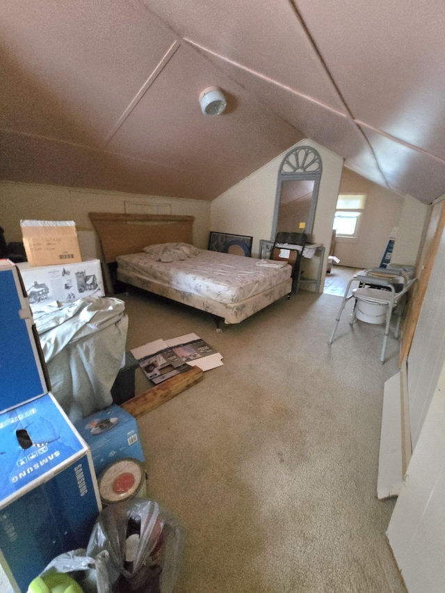 bedroom featuring carpet and vaulted ceiling