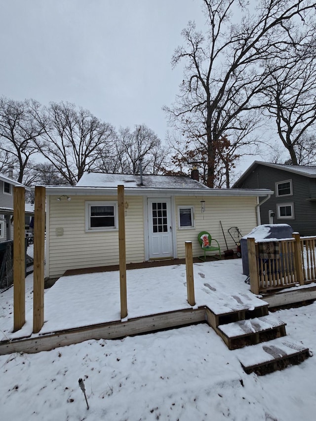 snow covered house with a garage