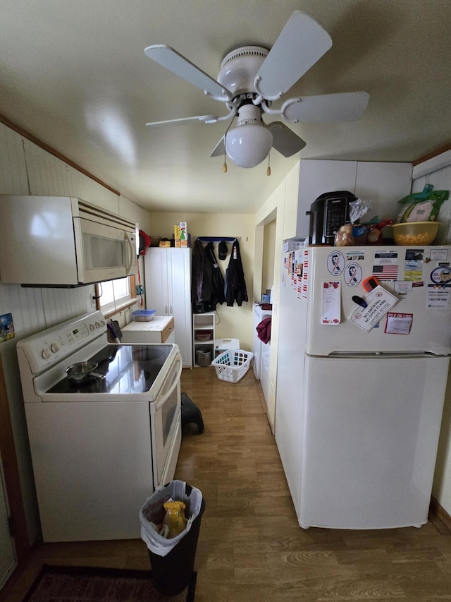 kitchen with white appliances, ceiling fan, and wood finished floors