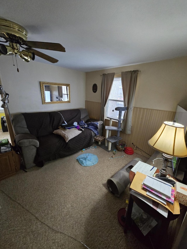 carpeted living room featuring a wainscoted wall and wood walls