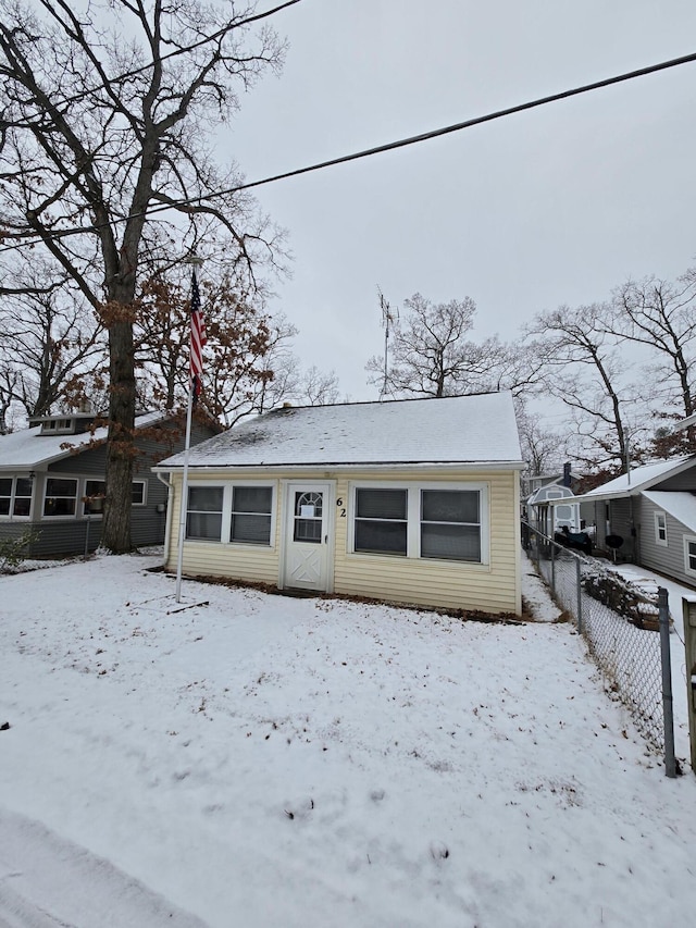 view of front of property with a garage and fence