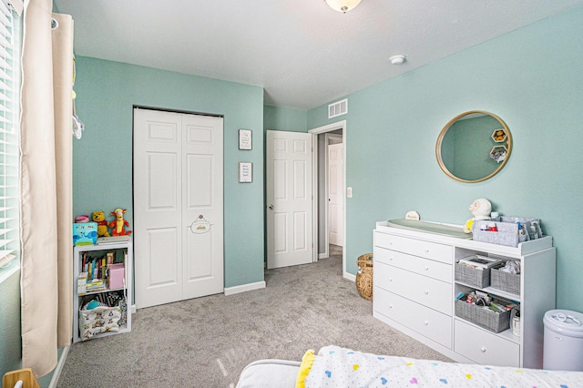 carpeted bedroom with visible vents and baseboards