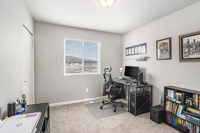 home office with carpet floors and baseboards