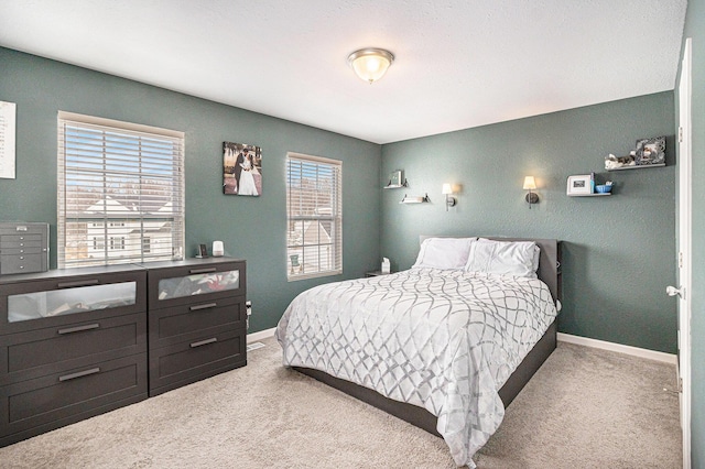 carpeted bedroom featuring baseboards