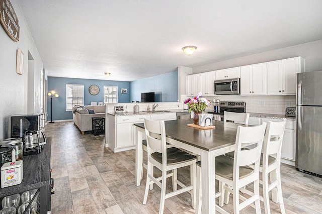 dining space with light wood-style flooring