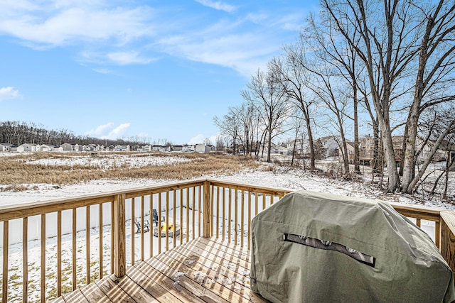 snow covered deck featuring area for grilling