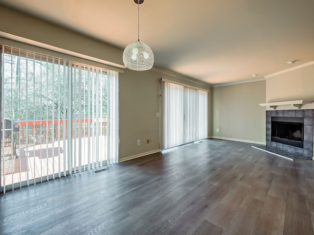 unfurnished living room featuring a fireplace, visible vents, crown molding, and wood finished floors