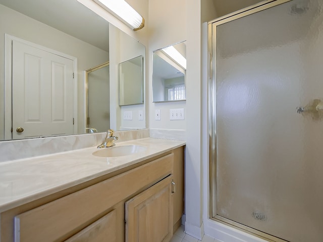 bathroom with a stall shower and vanity