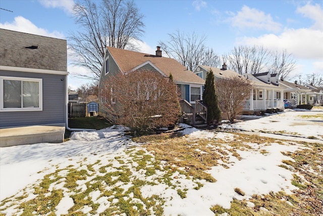 snow covered property featuring a residential view