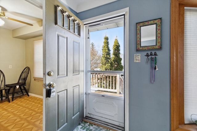 doorway to outside featuring baseboards