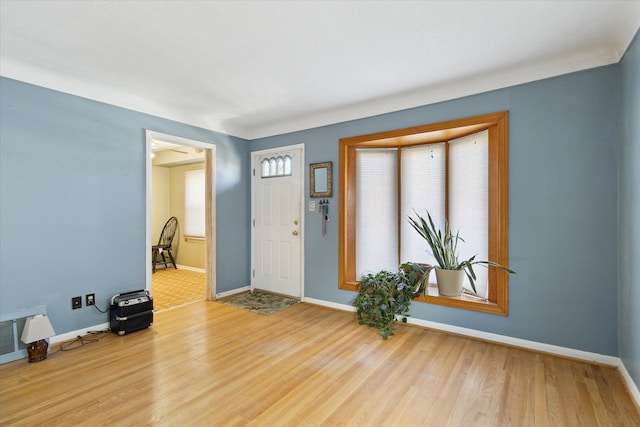 entryway with visible vents, baseboards, and wood finished floors