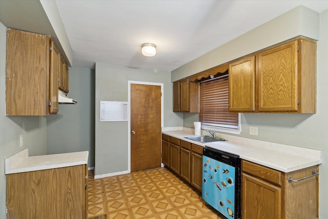 kitchen with a sink, light floors, light countertops, and dishwasher