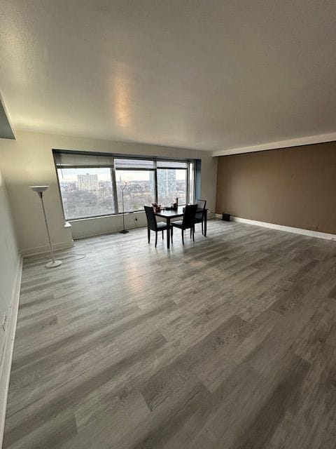 dining space featuring baseboards and wood finished floors